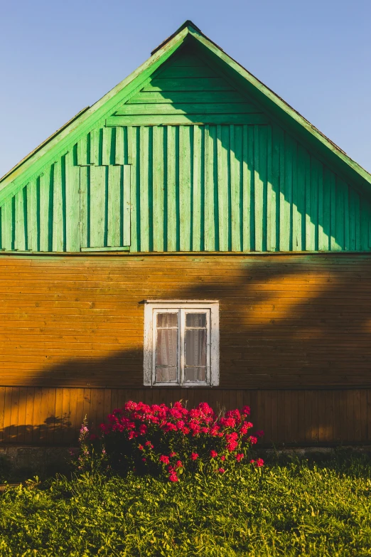 the shadow on a house shows its bright green paint