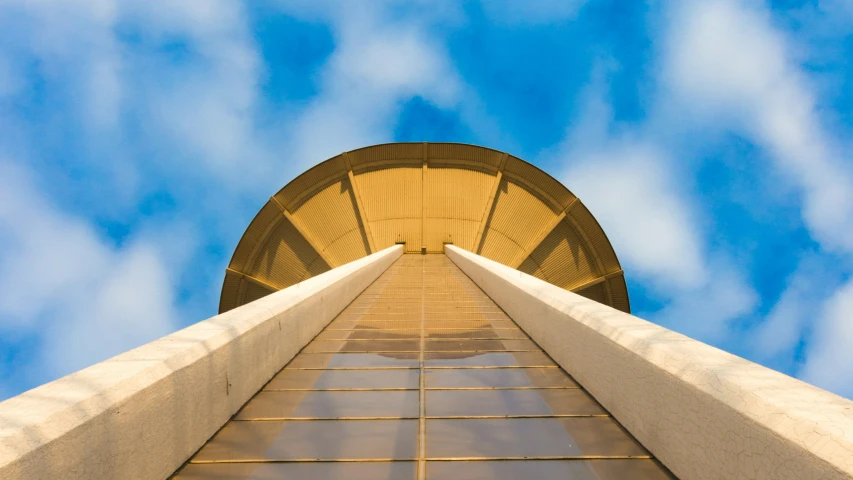 a tall building against a cloudy blue sky