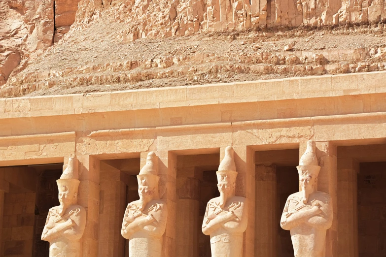 a large building with statues of men in front of it