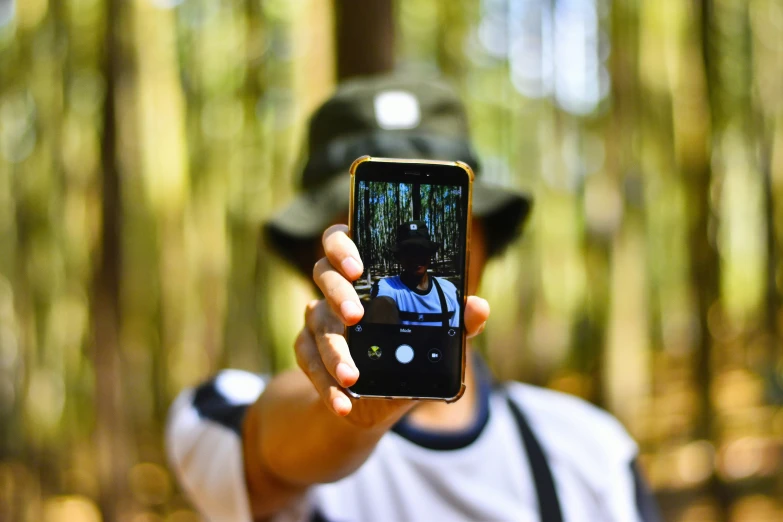 a person holding up their cell phone to take a po