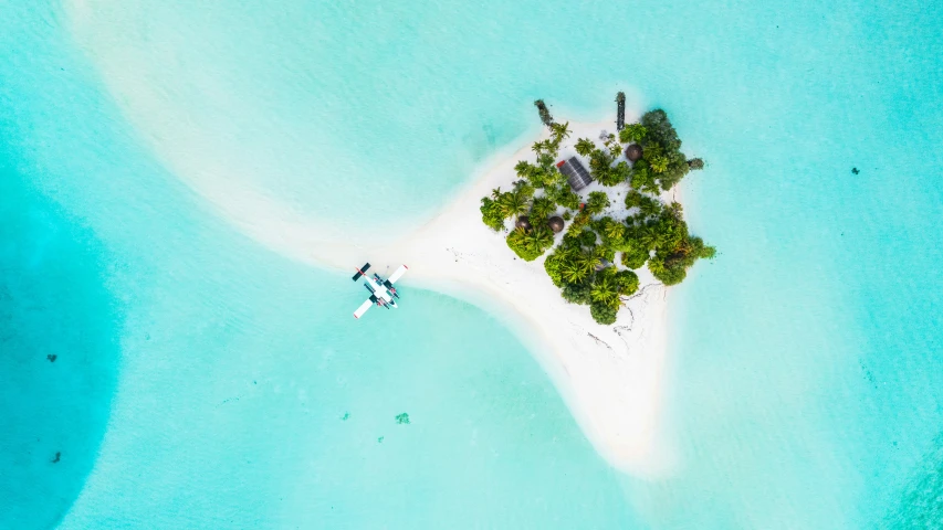 the water is clear and blue with a small island in it