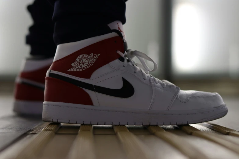 a pair of shoes is placed next to the wooden floor