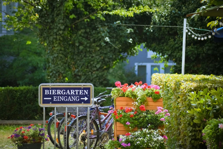 a sign for a village with several bikes parked in front