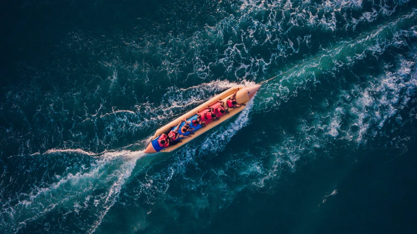 an overhead view of two people in a boat with people on top, looking down