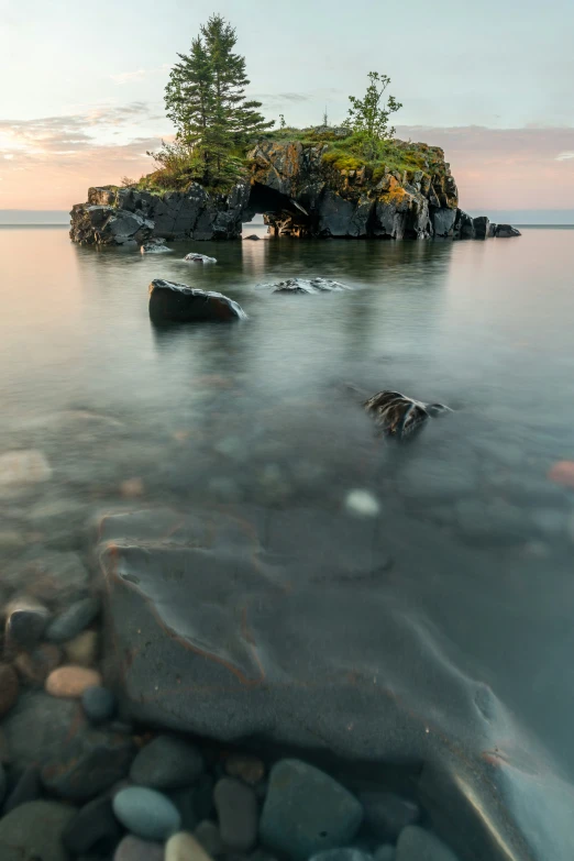 an island with trees on it at twilight