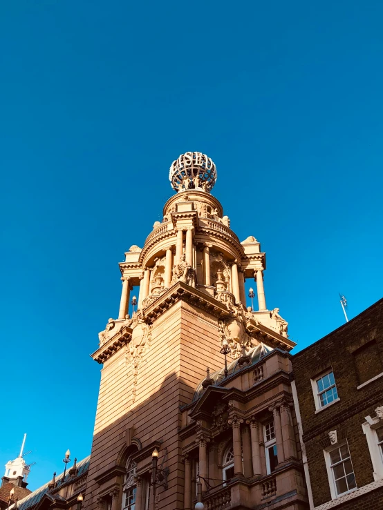 a tall building with clocks is shown against the sky