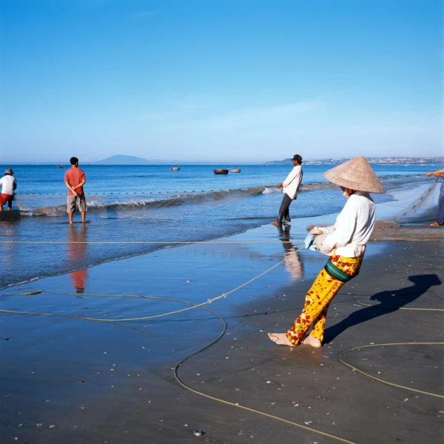 people are on the beach playing with their sand