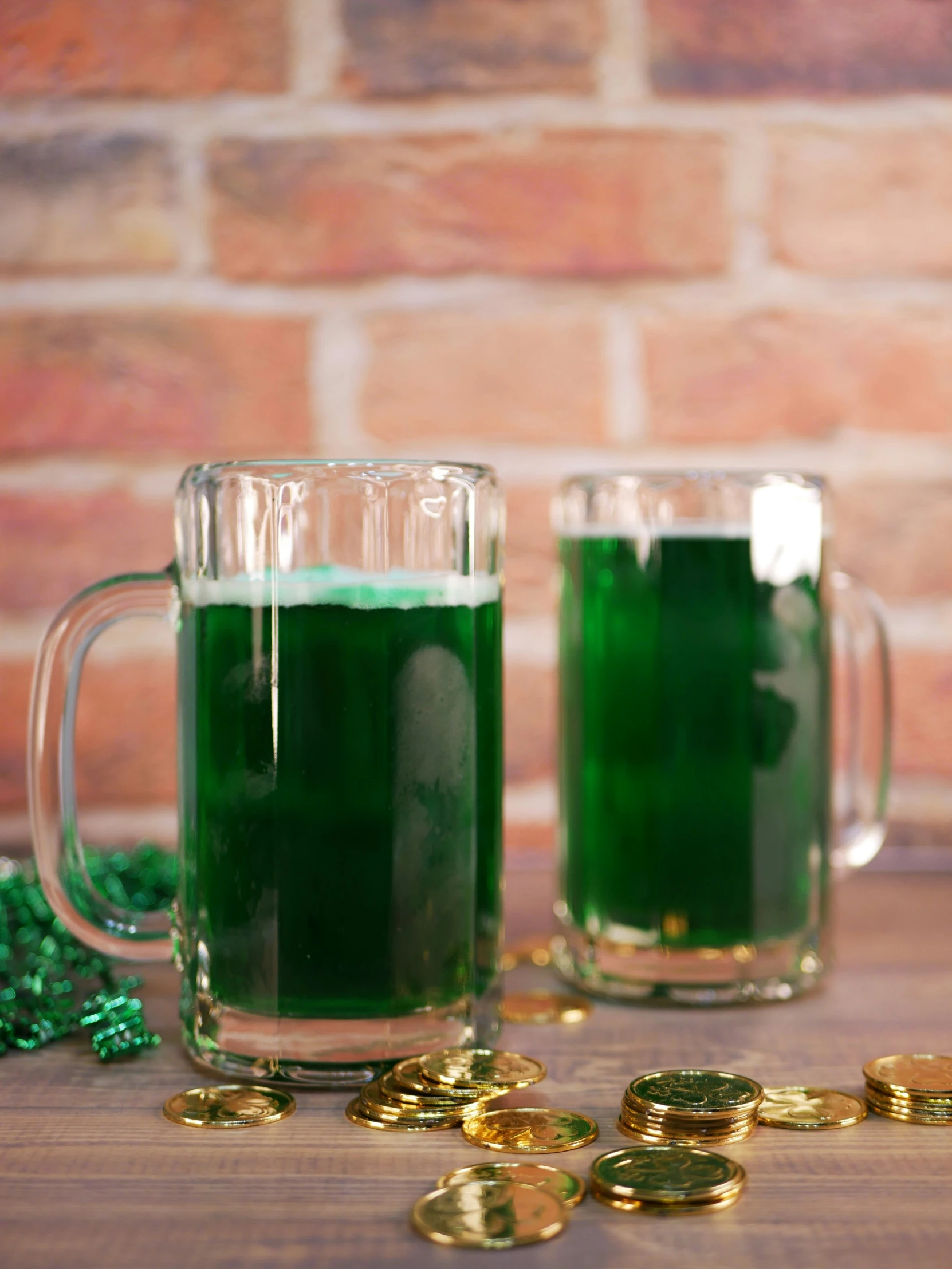 two glass mugs of green beverage on a table