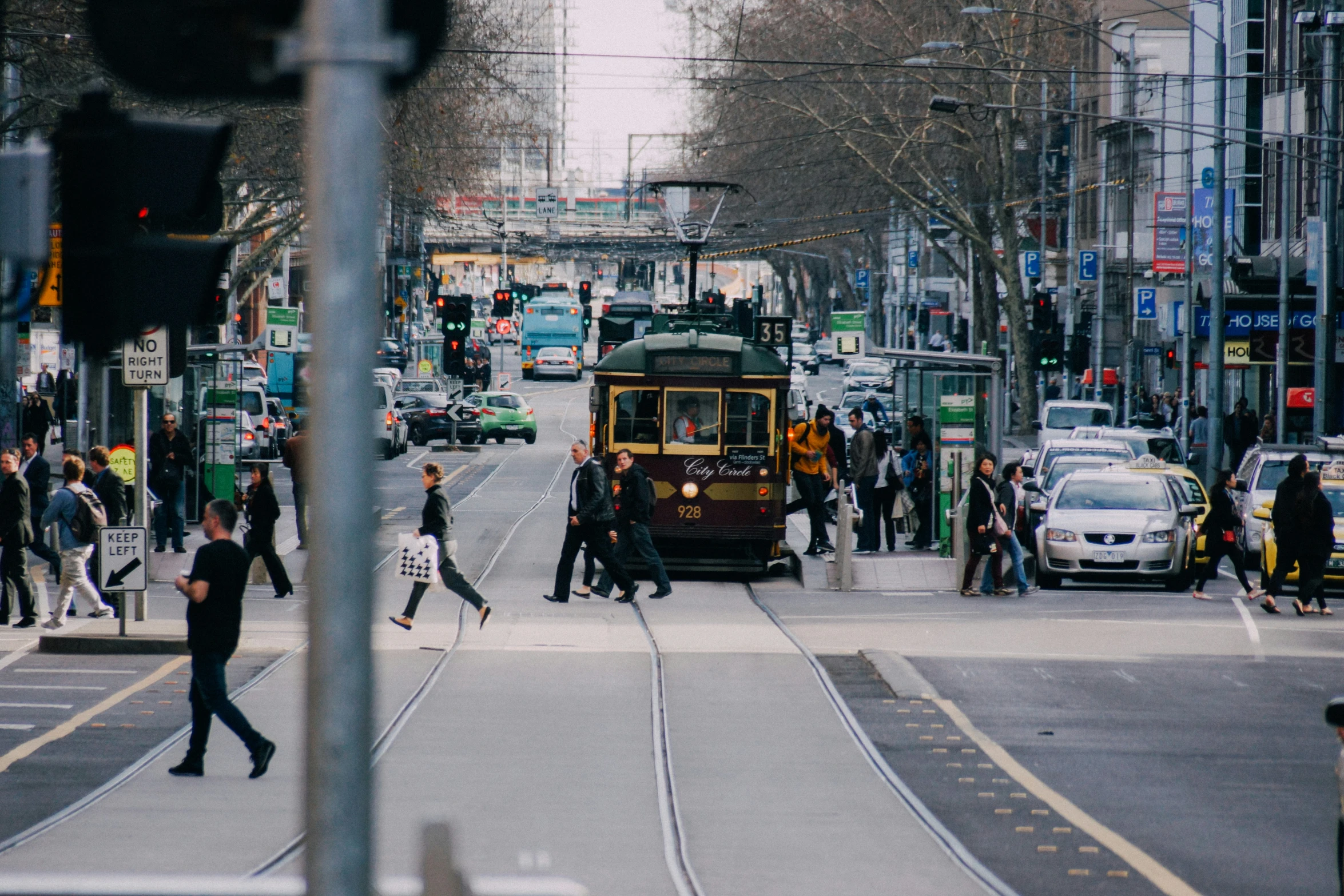 a city street is filled with people and vehicles