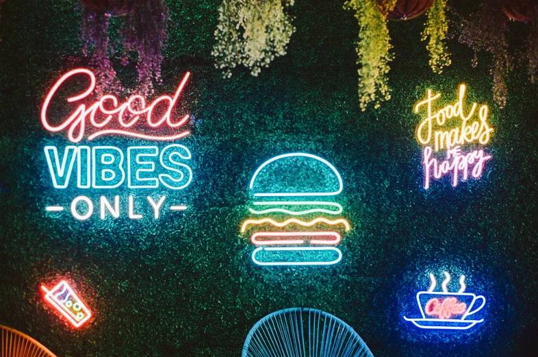 glowing signs on a wall in a restaurant