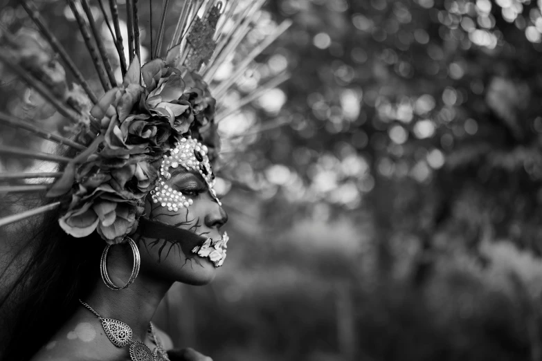 a woman with elaborate head pieces and jewelry on her face