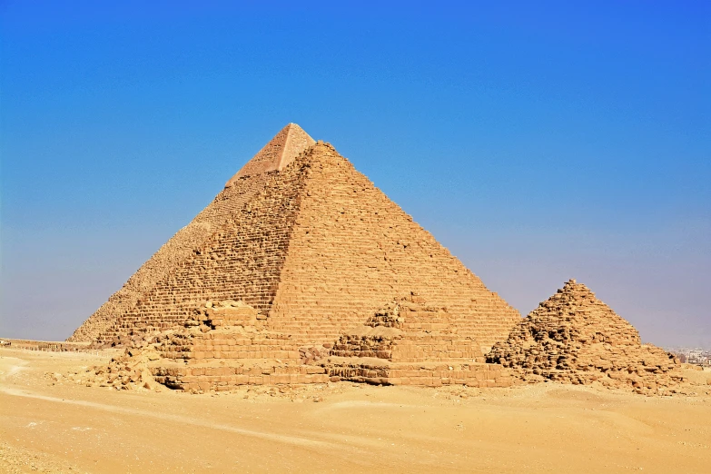 two large pyramids sit in a desert landscape