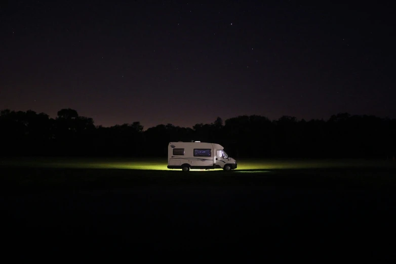 a small car is parked in the dark