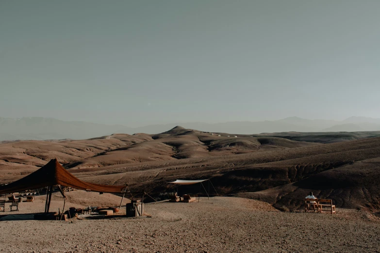 a field filled with brown colored desert mountains