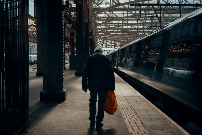 a person is walking at the train station in dark