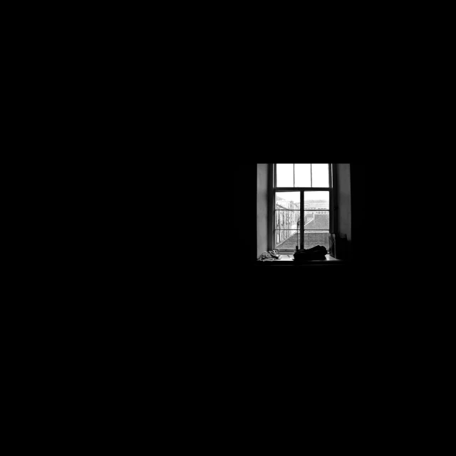 an empty room with a window and a curtain