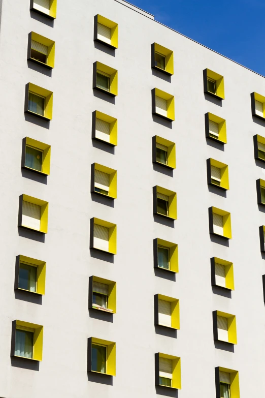 a large building with several windows and yellow lines