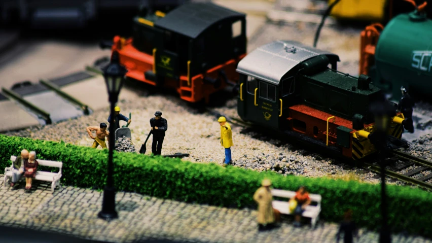 small toy people on a model train track