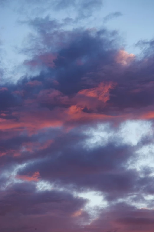 an airplane is flying in the cloudy sky