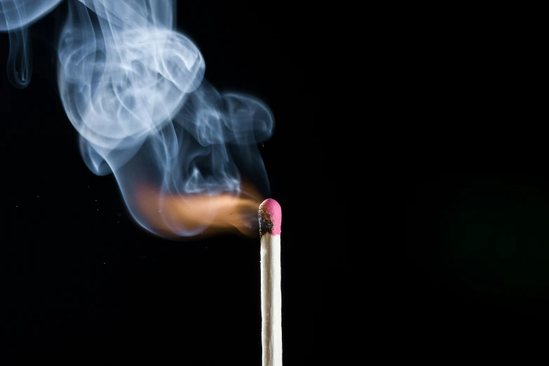 the top of a matchstick with a lit match