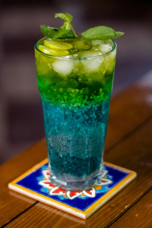 green and blue liquid with a leaf on top