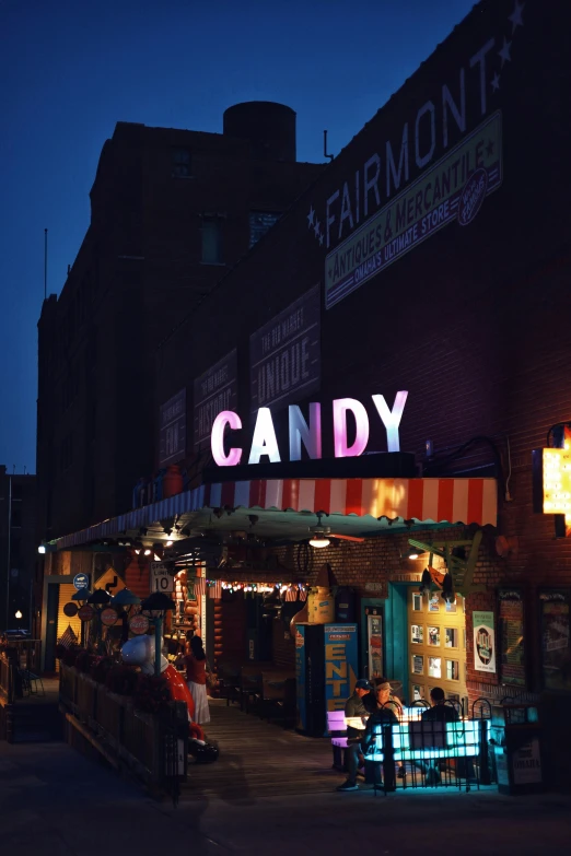 a store front decorated in neon colors with the letters candy lit up