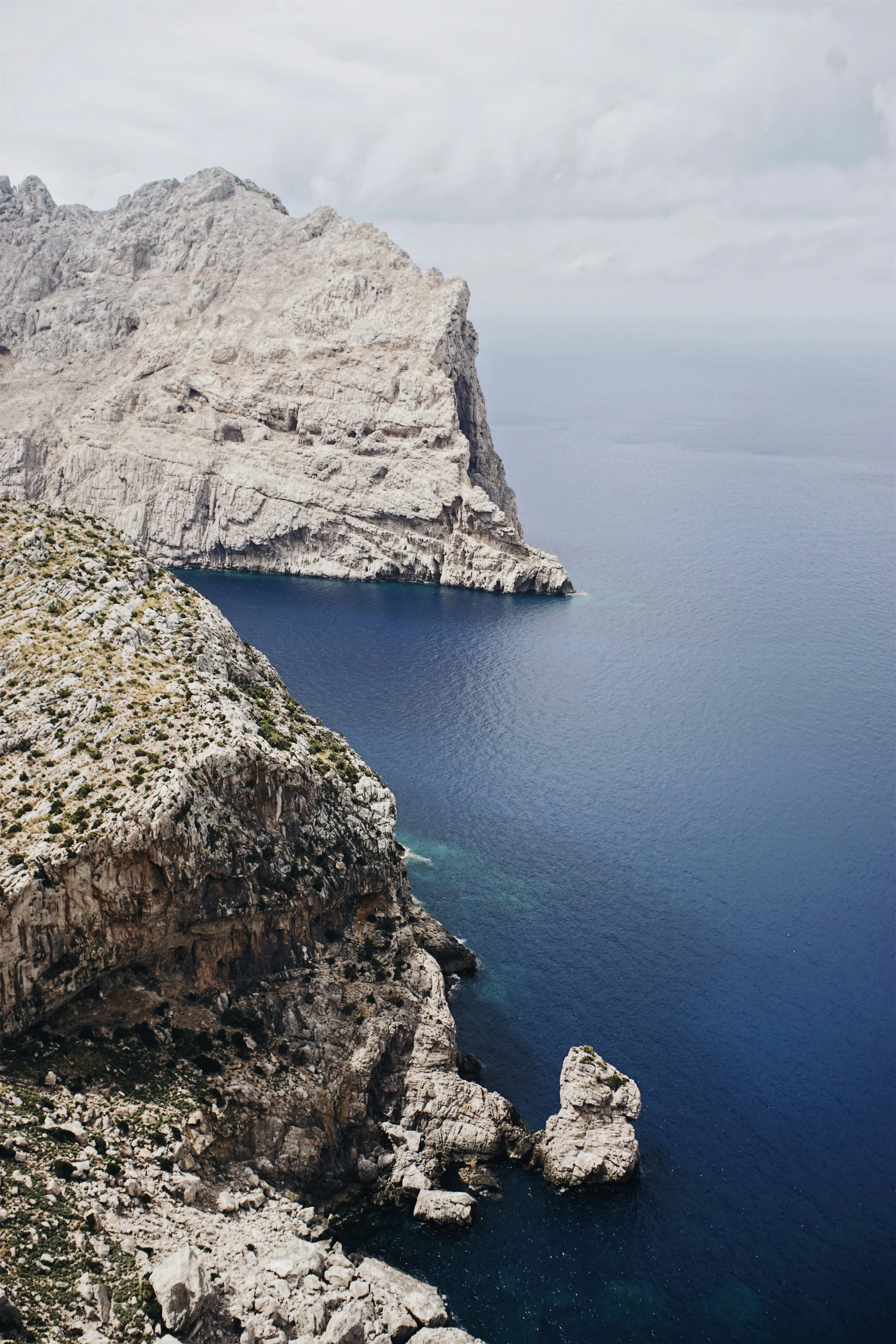 a body of water next to two mountain tops