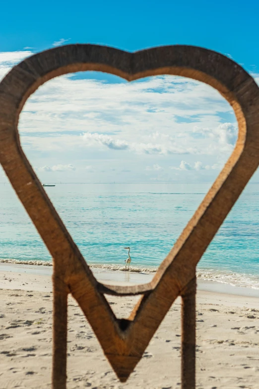 an image of a heart shape frame in the sand