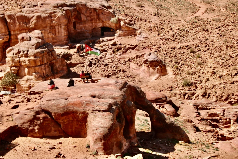 some very large rocks with small children near them