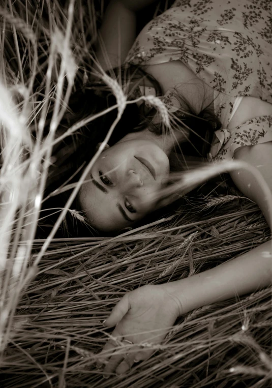 an old black and white po of a woman laying in the grass