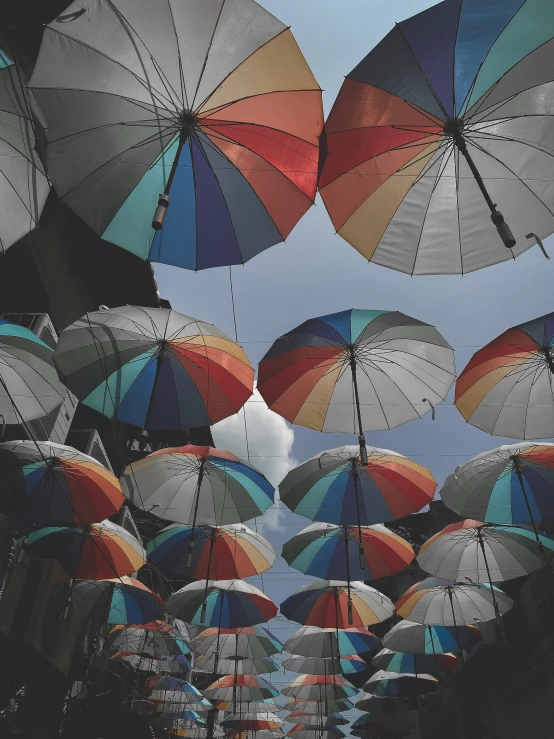 many colorful umbrellas in the middle of the street