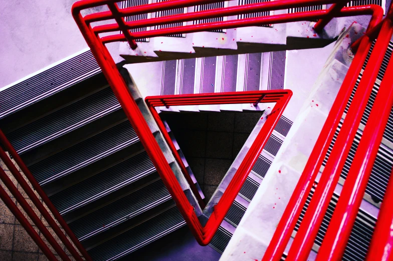 a red metal stair case with dividers on top of it