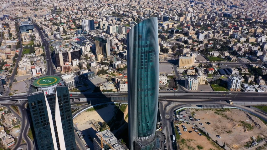 the aerial view of skyscrs, cars and highway in the middle