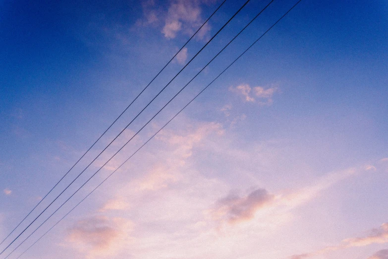 a stop sign is by the power lines at dusk