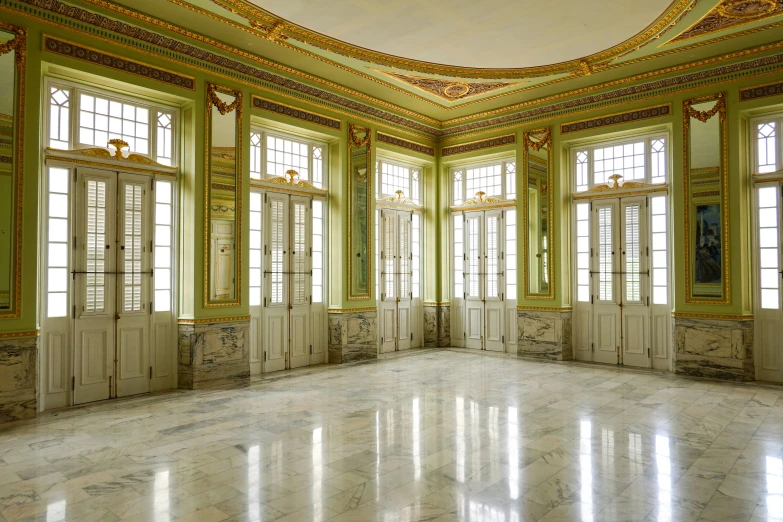 an empty ballroom in a building with windows