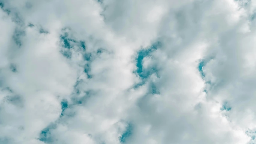 some fluffy clouds are in the blue sky