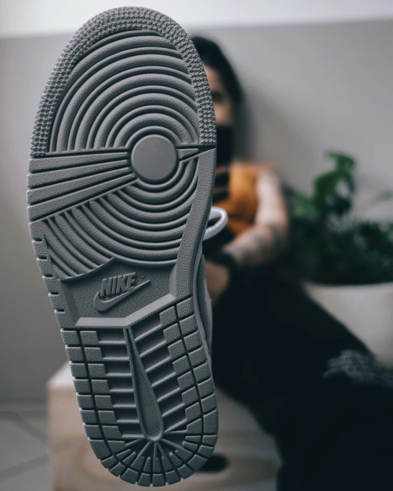 a person sitting down and looking at their shoe