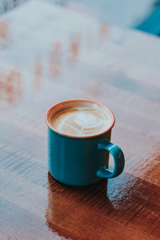 a coffee cup sitting on top of a wooden table