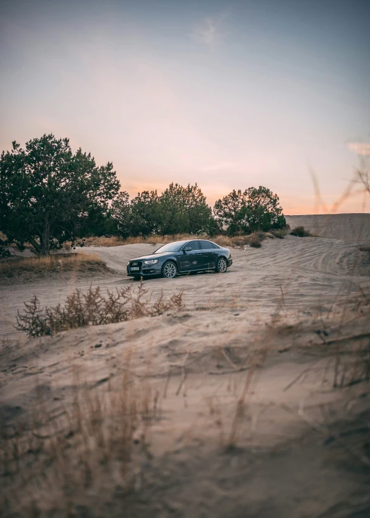 the gray car is sitting in the field