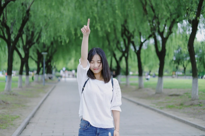 a woman holds up her hand with the fingers