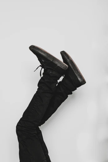 a black and white po of the boots hanging off of a ledge