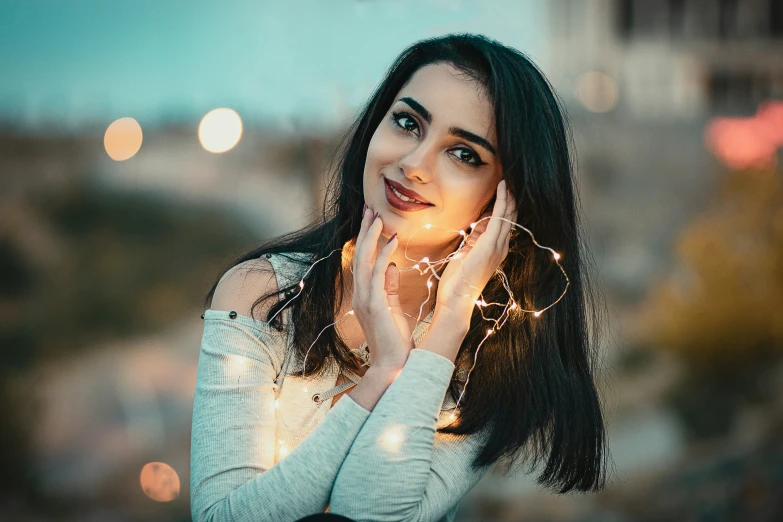 a woman holds her face to her cheeks with her hands