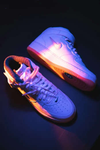 glowing sneakers are on a dark surface