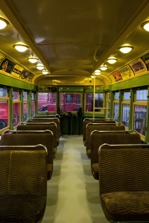 the interior of a train that has yellow lit ceilings
