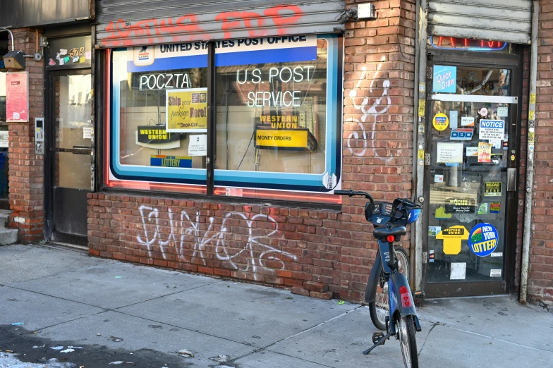 a bicycle is parked in front of the store