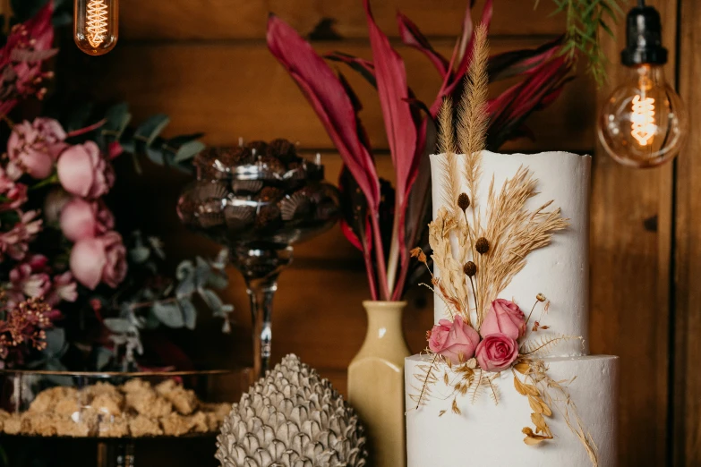 several vases of flowers in front of a wall