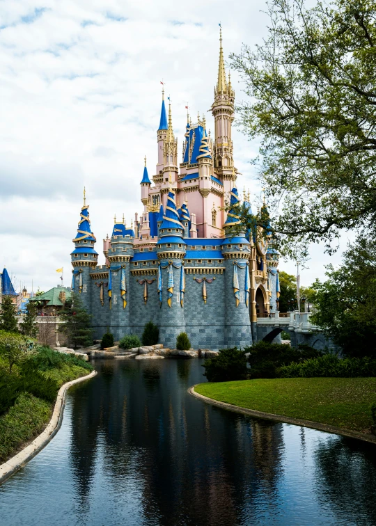 a large building is next to the water and has gold towers