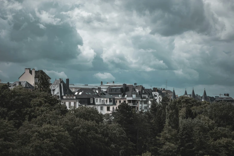 a lot of houses under some ominous clouds