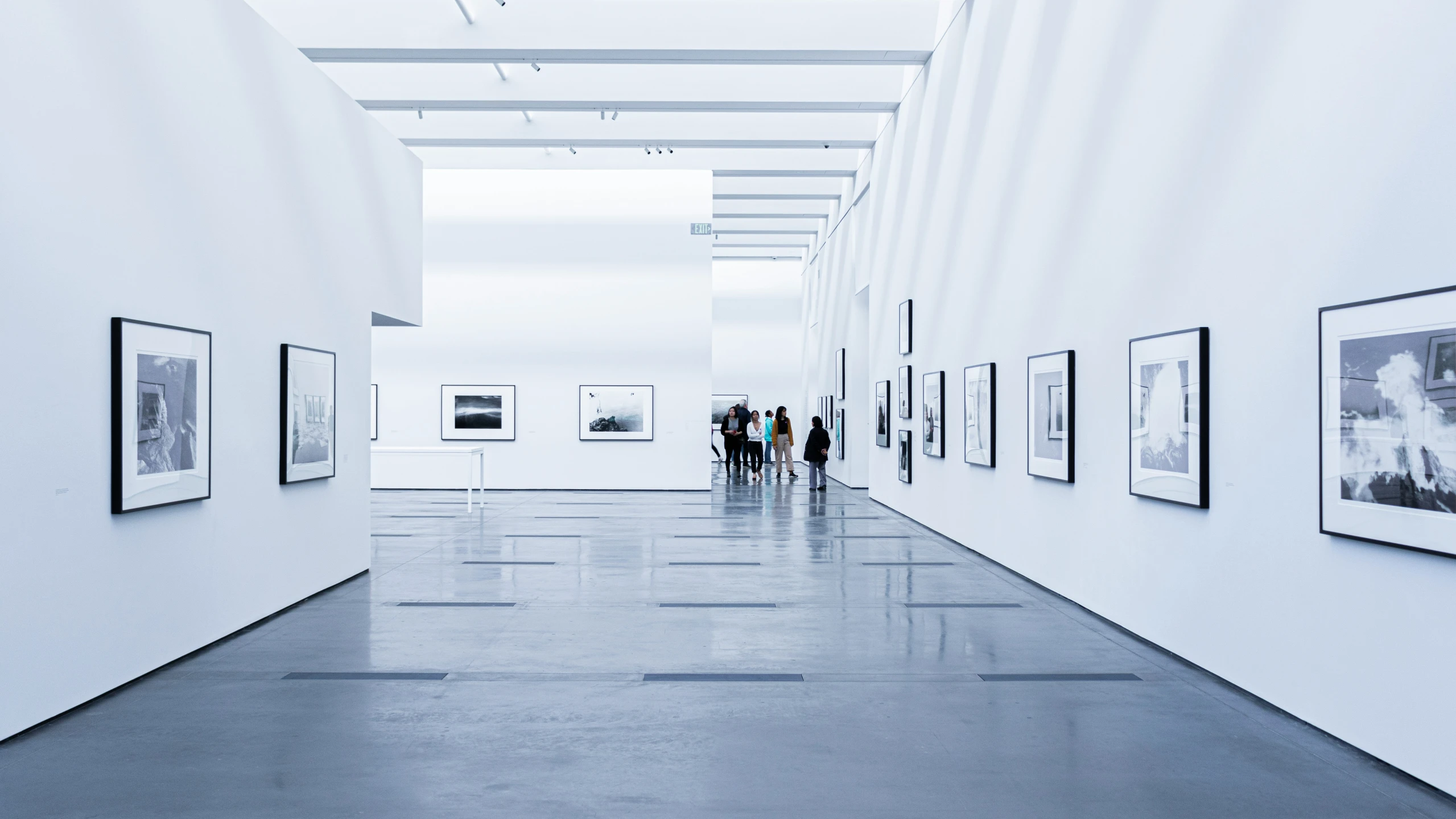 an open hallway with people walking through it