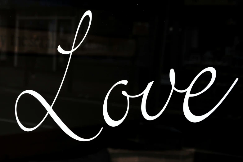 the window that has a reflection of the word love in it